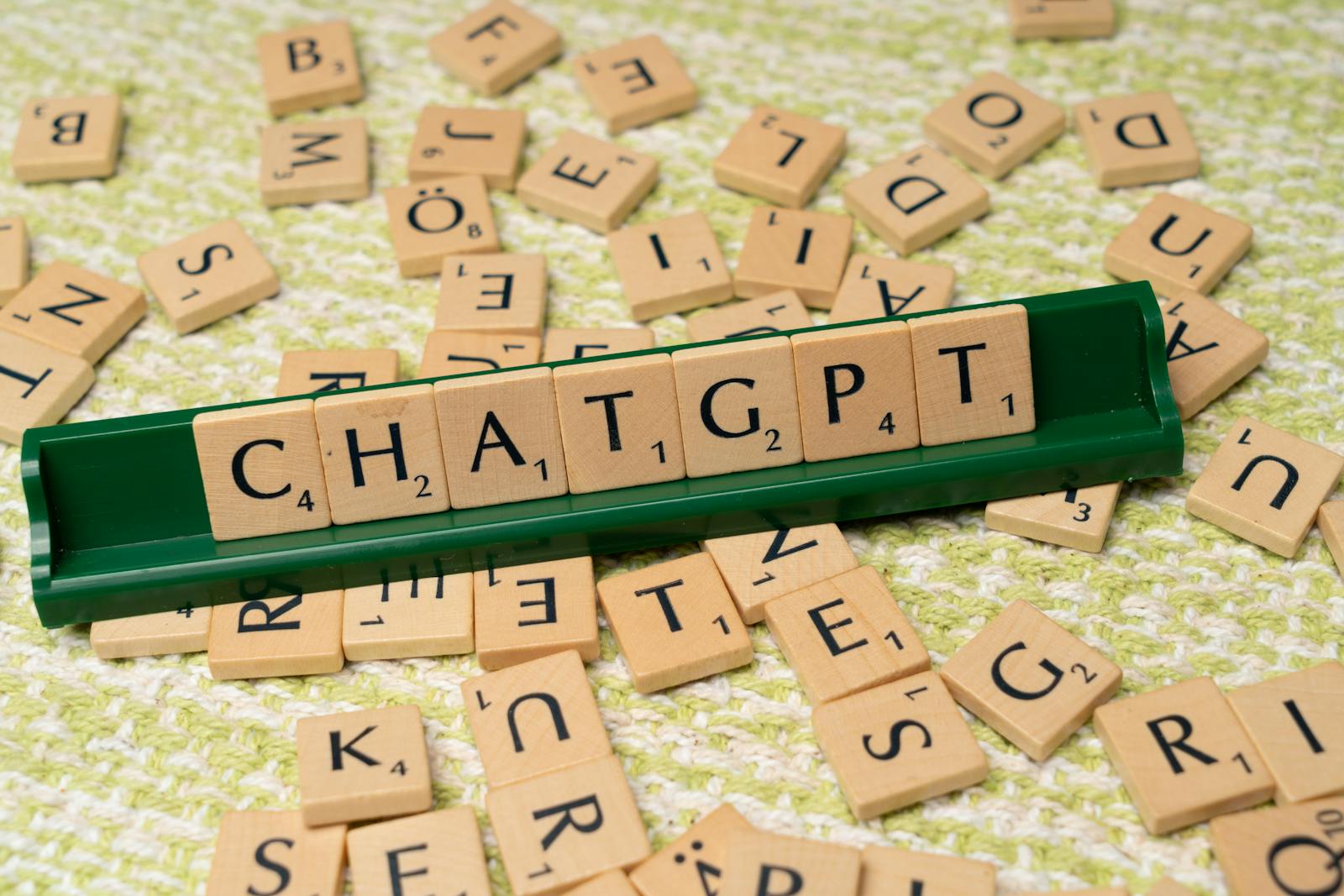 Ferienpass Weinfelden - Chat GPT | Scrabble game spelling 'CHATGPT' with wooden tiles on textured background.