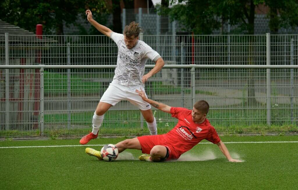 A couple of men playing a game of soccer