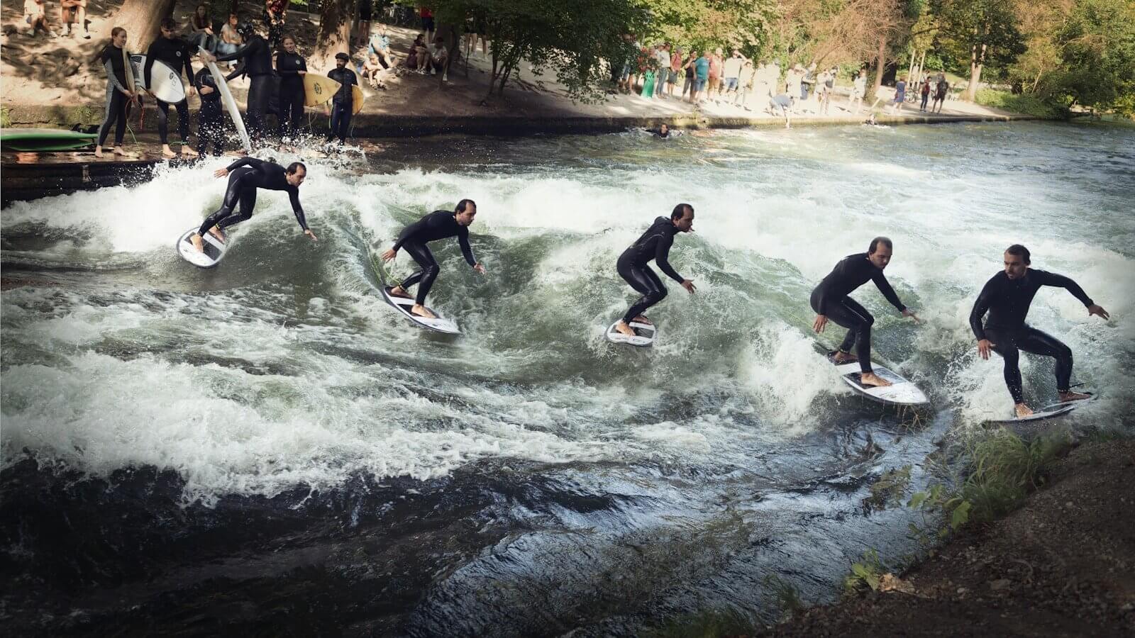 Ferienpass Romanshorn: Surfen in der Schweiz 1 A group of people riding surfboards on top of a river