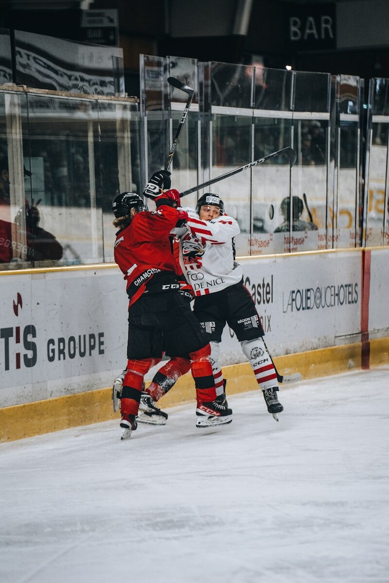 A group of people playing a game of ice hockey