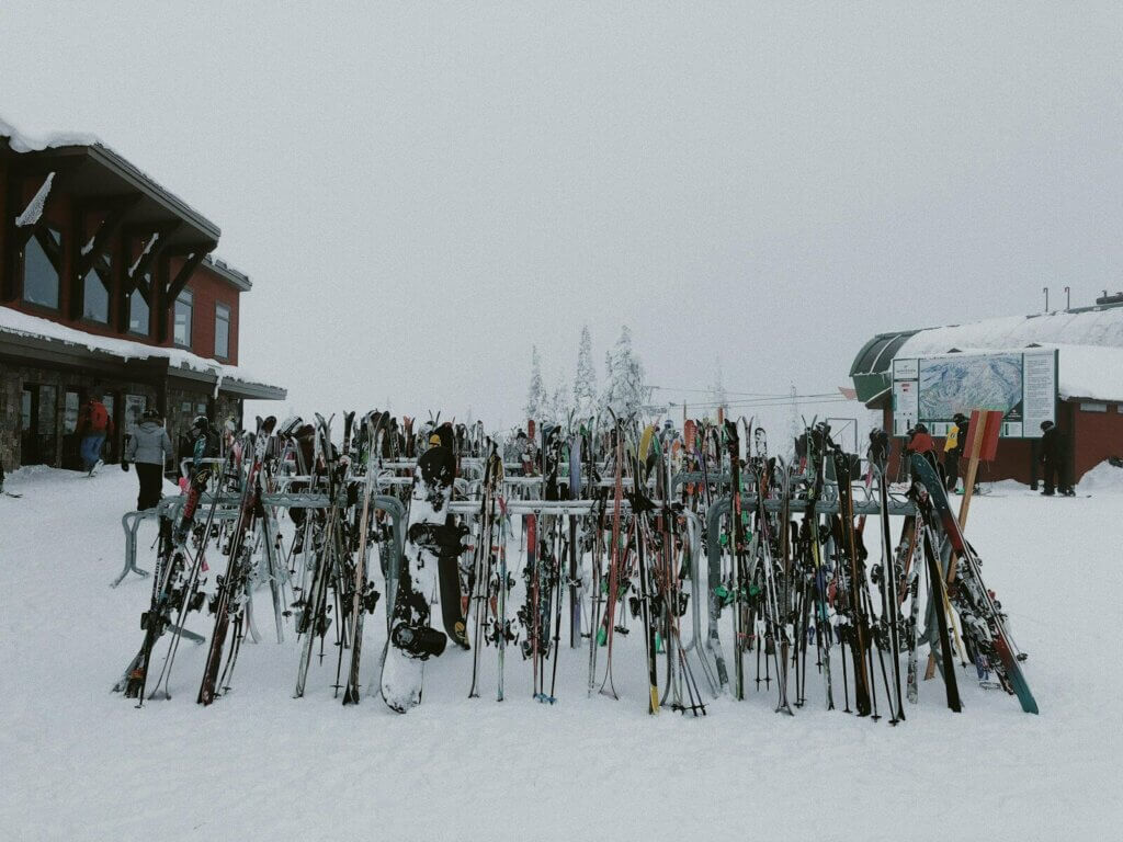 people riding ski blades on snow covered ground during daytime