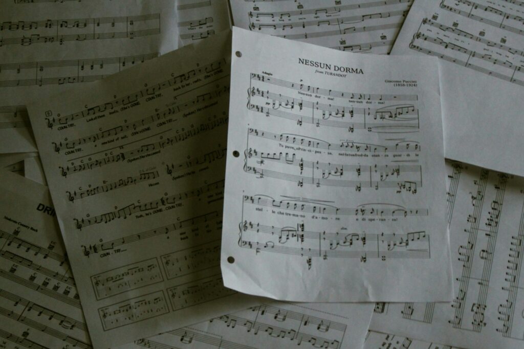A pile of sheet music sitting on top of a table