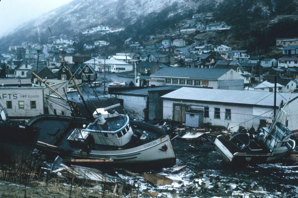 Fishing boats grounded on debris in a coastal town after a natural disaster