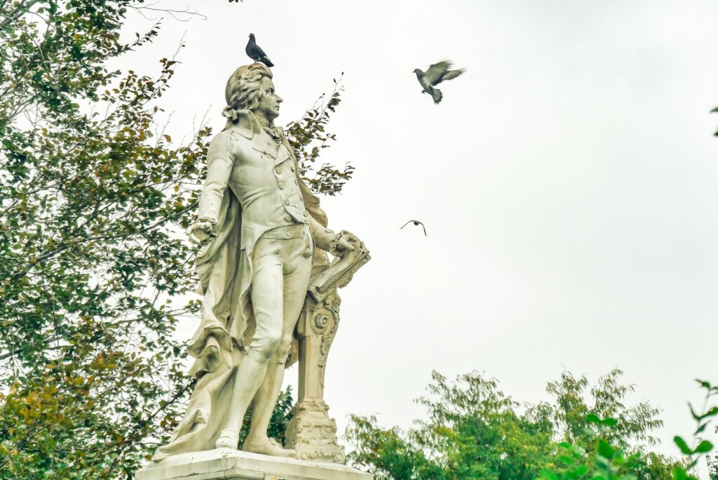 a statue of a man with a bird on his shoulder