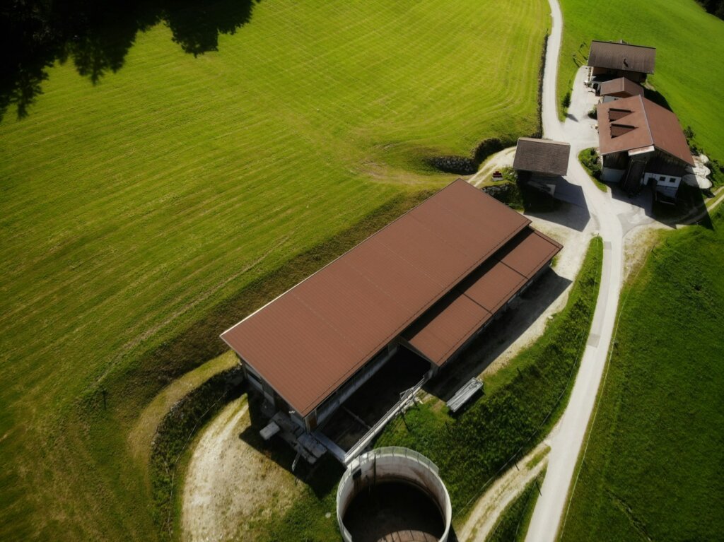 an aerial view of a farm with two barns