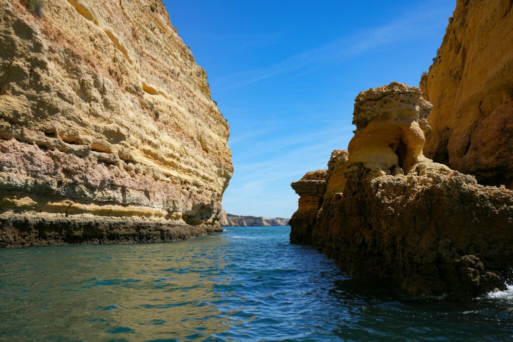 a body of water near a rocky cliff